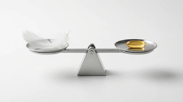 Studio photography of a Phosphatidylserine capsule balancing perfectly with a white feather on a scale, visualizing the supplement's gentle safety profile and minimal side effects.